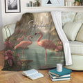 Flamingo blanket draped over a sofa with tropical birds, flowers, palms, and a peaceful lagoon design