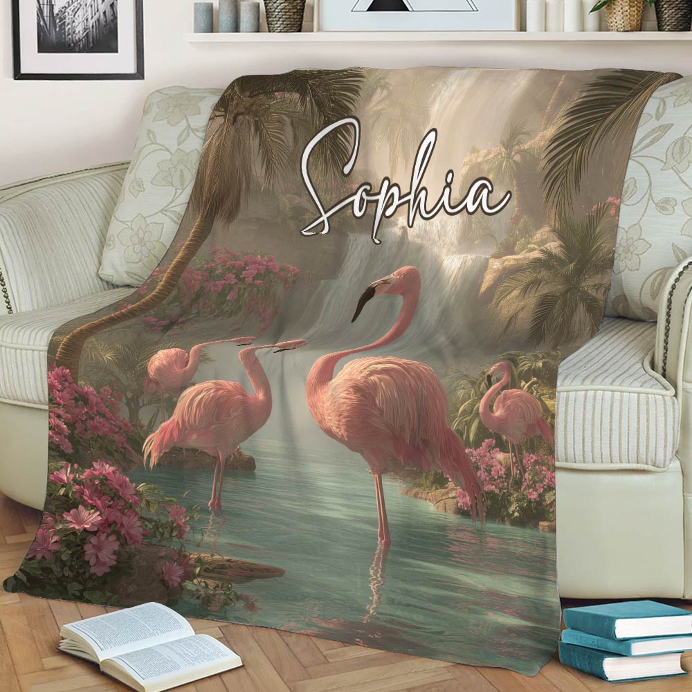 Tropical flamingo throw blanket displayed on a sofa with pink birds, palm trees, and lush flowers