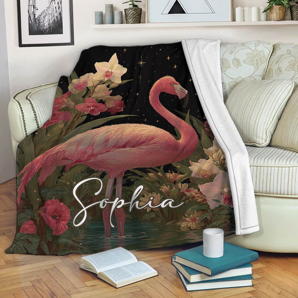 Flamingo throw blanket draped over a sofa with colorful flowers and celestial accents