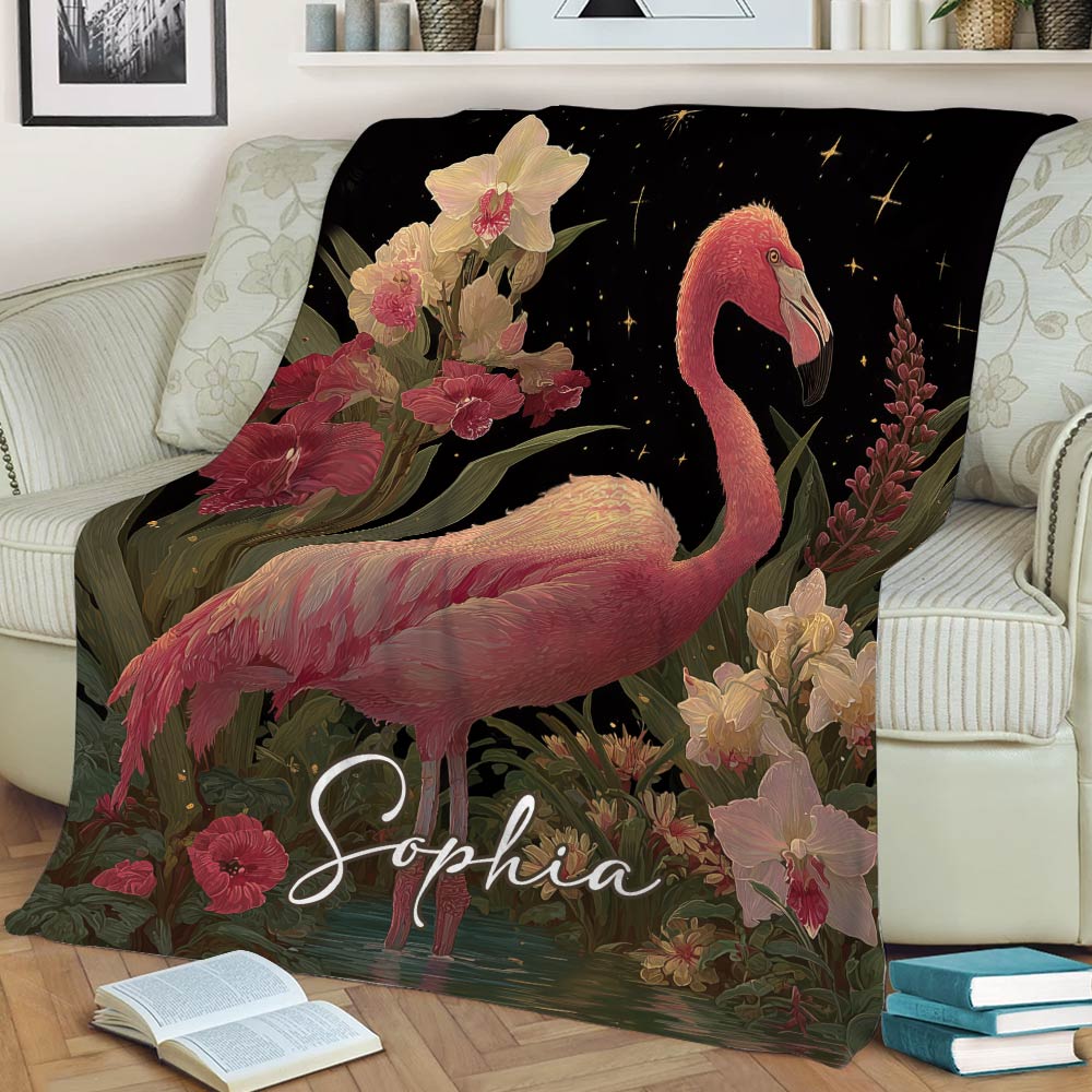Flamingo blanket styled across a sofa with pink floral artwork and botanical details