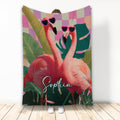 Colorful flamingo throw blanket with tropical leaves, pink checkerboard accents, and heart-shaped sunglasses