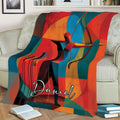 Geometric archer throw blanket displayed across a sofa with bold red, teal, orange and yellow artwork