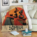African culture blanket draped over a sofa with colorful figures, geometric patterns, and warm earth tones
