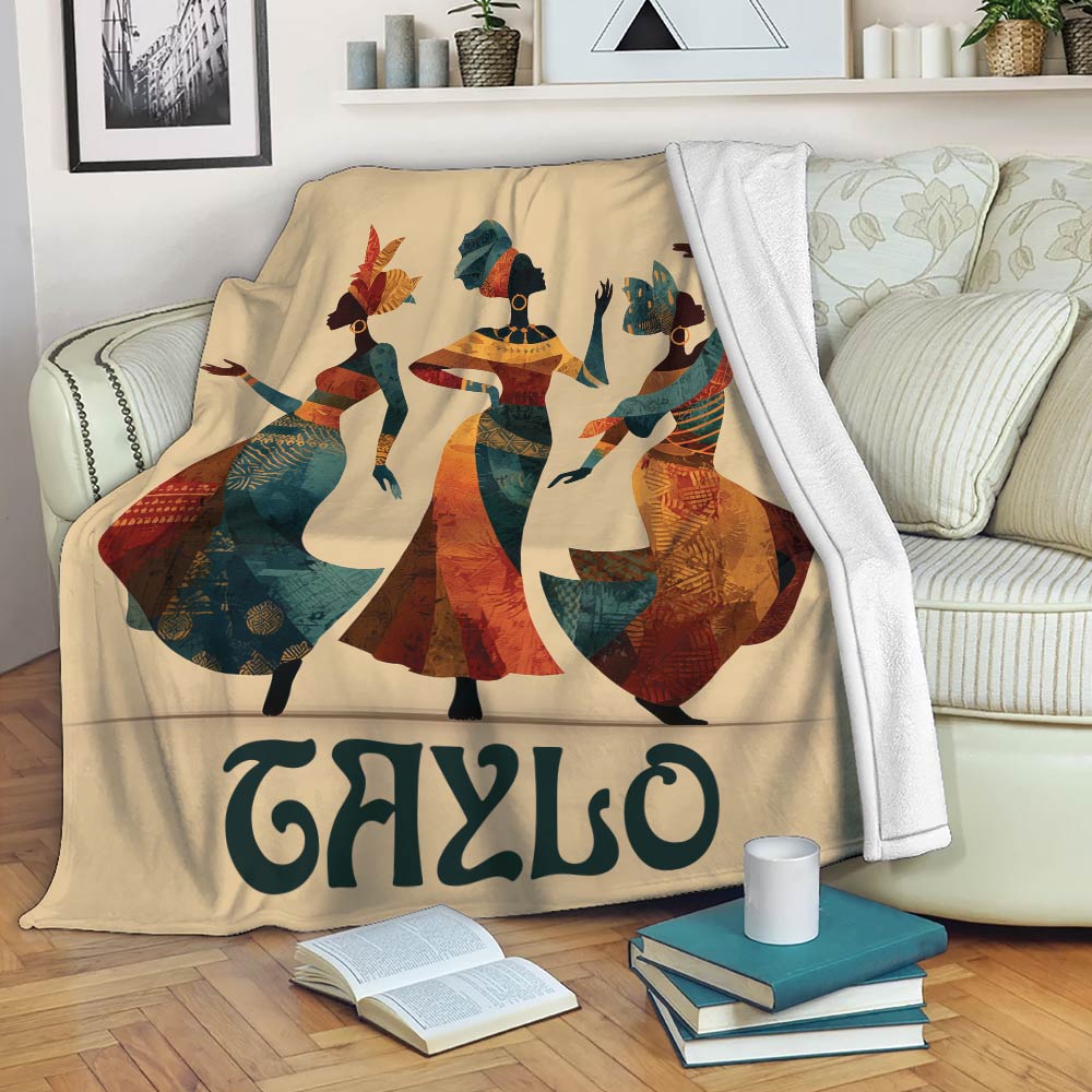 African art throw blanket draped over a sofa with three colorful female figures