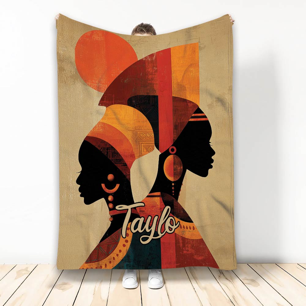 African-inspired blanket with two female silhouettes, geometric patterns, and warm red, orange, and black artwork