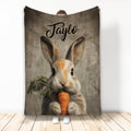 Rabbit throw blanket featuring a realistic bunny holding a carrot against a rustic wood-look background