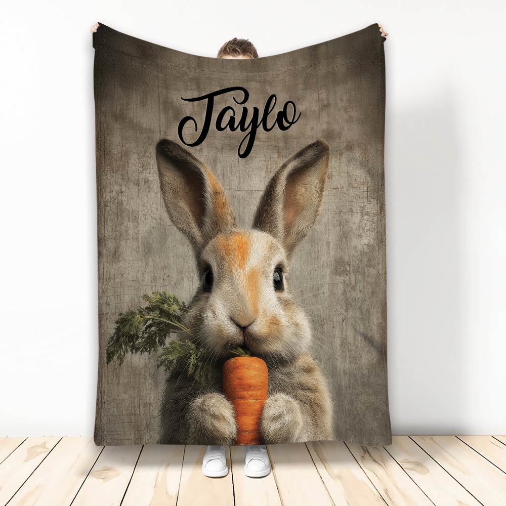 Rabbit throw blanket featuring a realistic bunny holding a carrot against a rustic wood-look background
