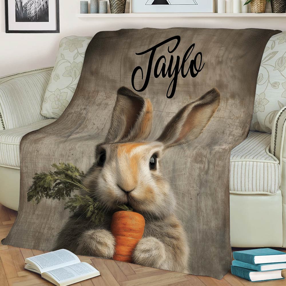 Close view of a realistic rabbit and carrot blanket styled across a sofa with books nearby