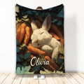 Rabbit blanket featuring a sleeping white bunny nestled among carrots and dark leafy garden foliage