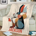 Modern geometric bunny throw blanket draped over a sofa with books nearby
