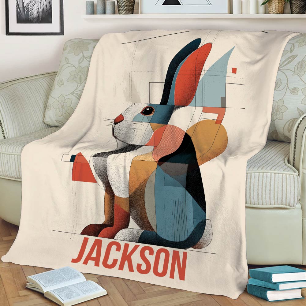 Modern geometric bunny throw blanket draped over a sofa with books nearby