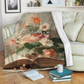 Floral book-themed blanket draped over a sofa in a cozy reading room