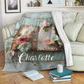 Floral open book throw blanket draped across a sofa in a cozy reading room