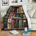 Book lover throw blanket displayed on a sofa with open books and floral bookshelf artwork