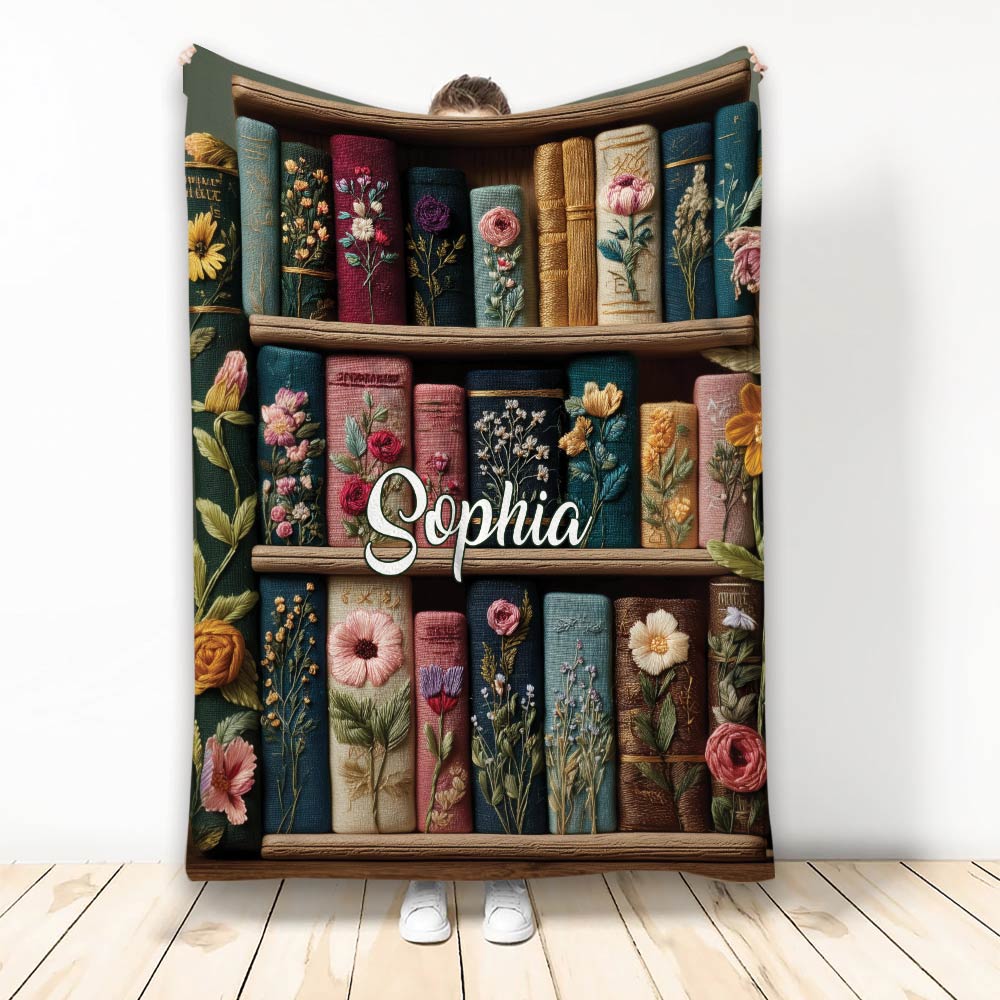 Book-themed blanket with colorful floral book spines arranged on wooden shelves