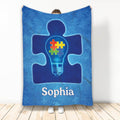 Autism awareness throw blanket with a blue puzzle-piece figure and colorful puzzle pieces