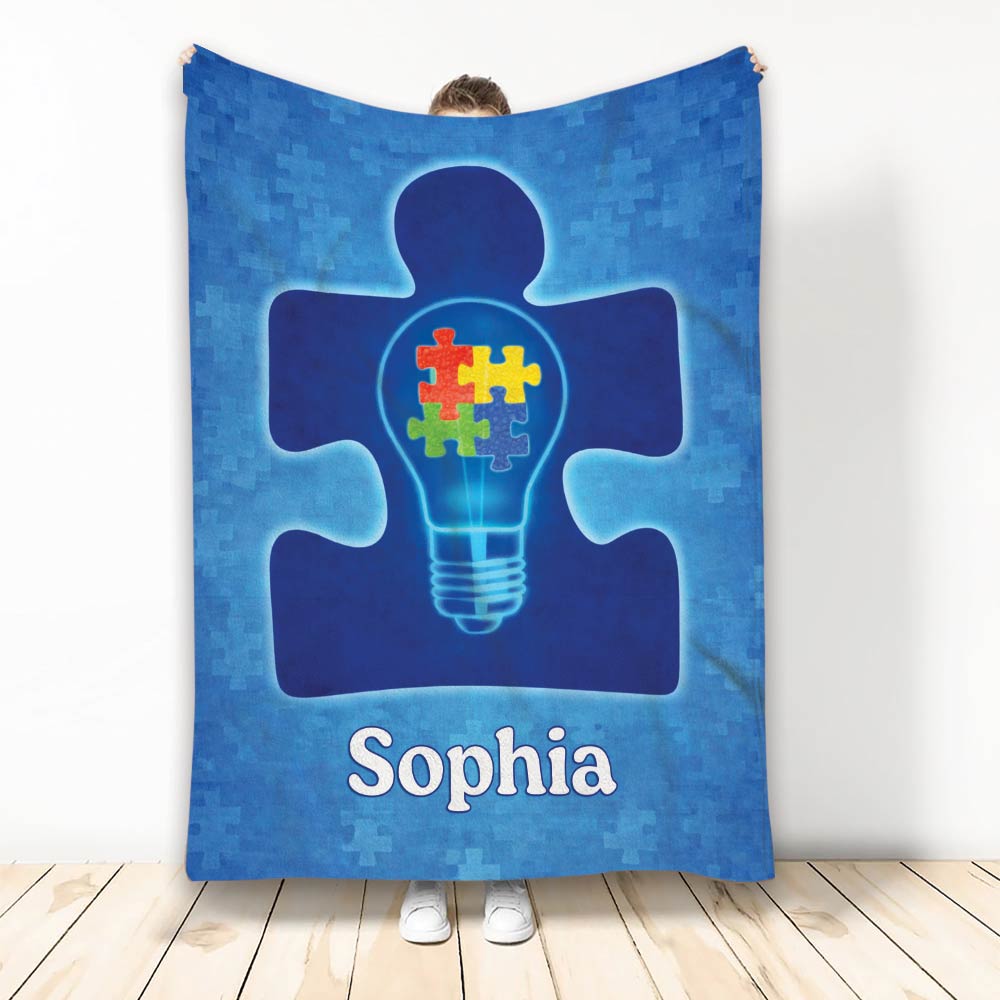 Autism awareness throw blanket with a blue puzzle-piece figure and colorful puzzle pieces