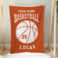 Orange basketball blanket displayed on a wooden frame with varsity-style sports artwork