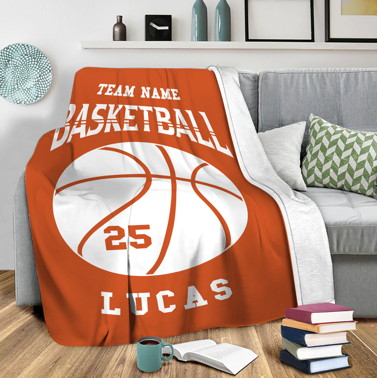Custom basketball throw blanket draped over a gray sofa in a cozy living room setting