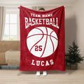 Red basketball blanket displayed in a living room with bold white basketball artwork and sports typography