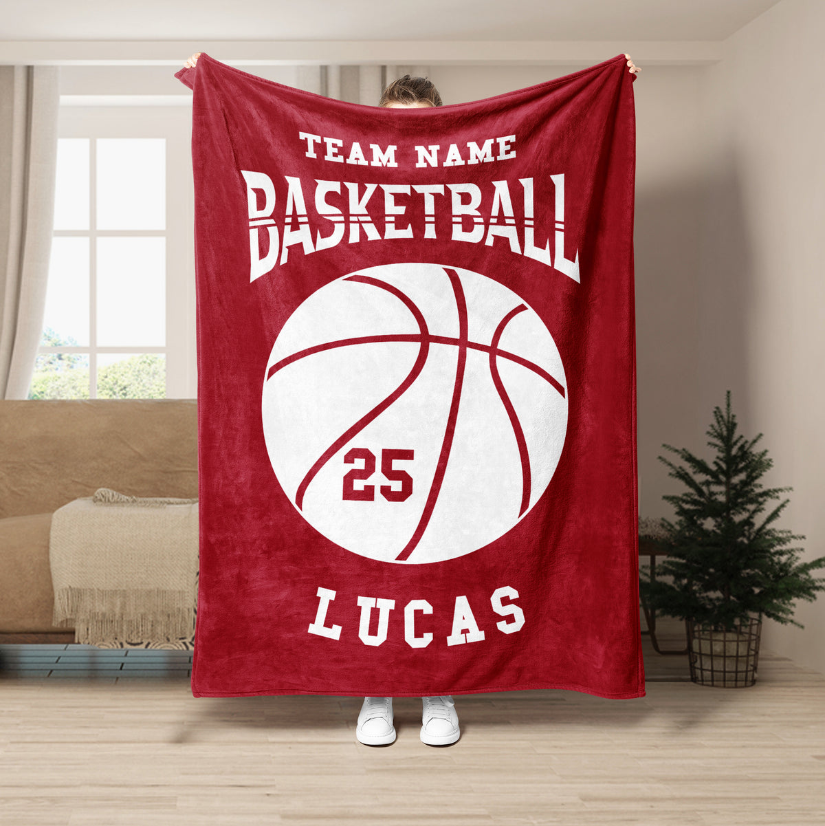 Red basketball blanket displayed in a living room with bold white basketball artwork and sports typography