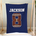 Football blanket hanging above a bed with bold varsity-style sports artwork