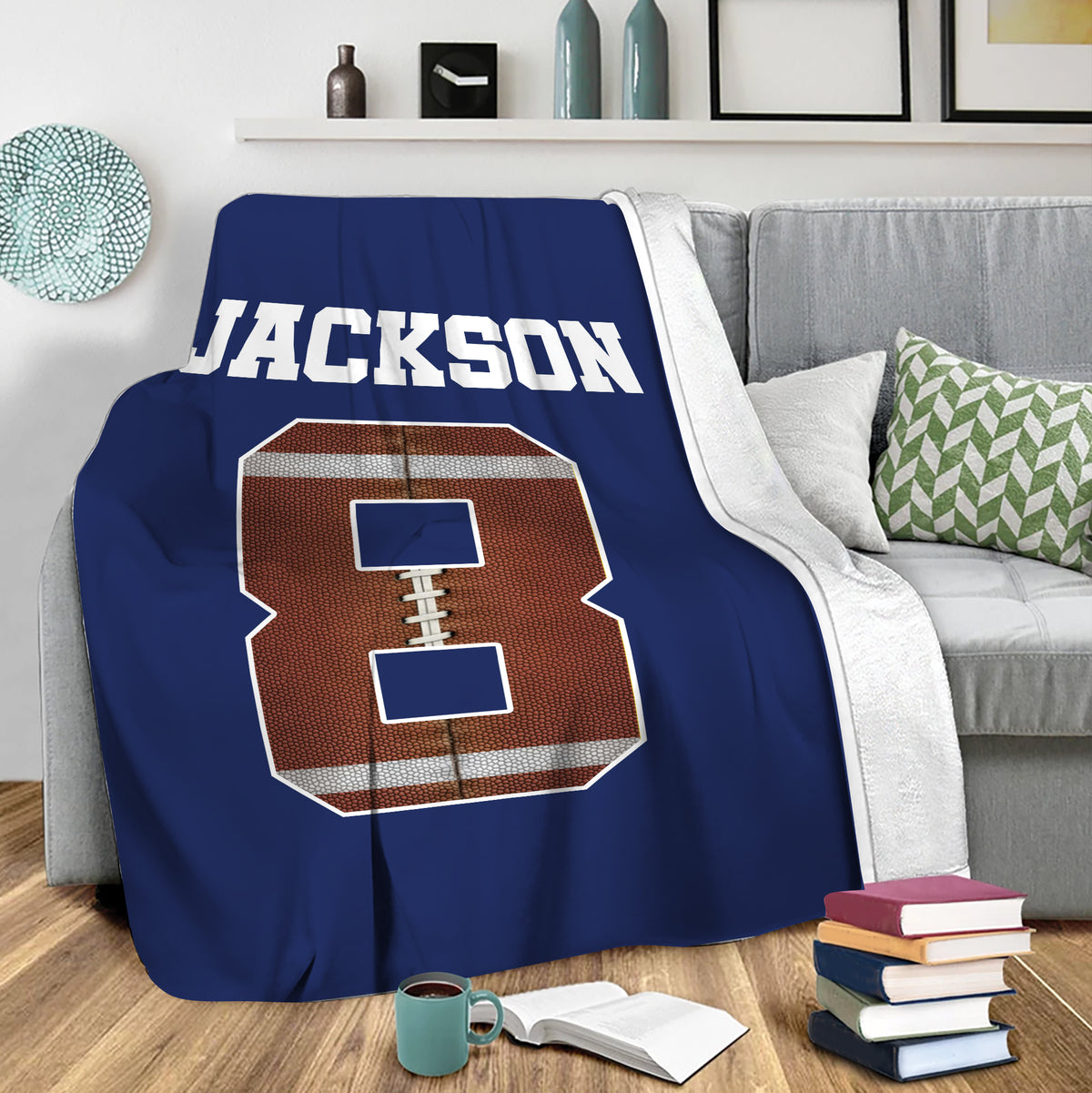 Navy football throw blanket draped over a sofa in a cozy living room