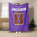Purple football throw blanket displayed with bold white sports lettering and football artwork