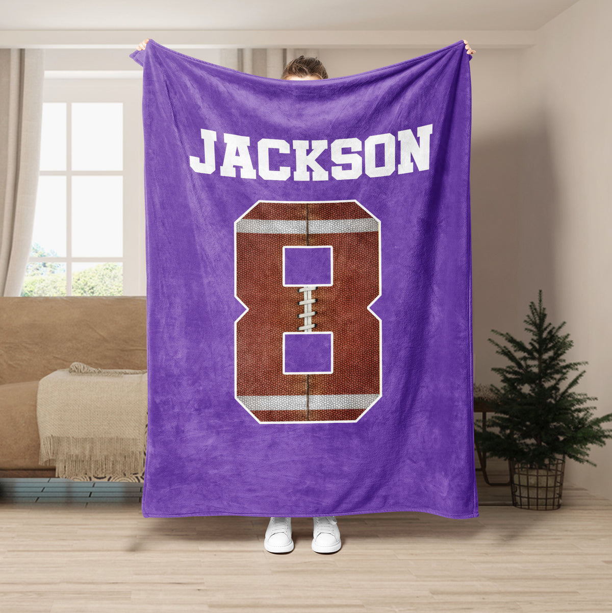 Purple football throw blanket displayed with bold white sports lettering and football artwork