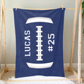 Blue football blanket hanging on a wooden display frame with bold white football artwork