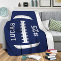 Blue football throw blanket draped over a sofa for cozy sports-themed living room decor