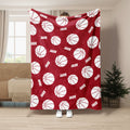 Red basketball throw blanket with repeating white basketball pattern in a room setting