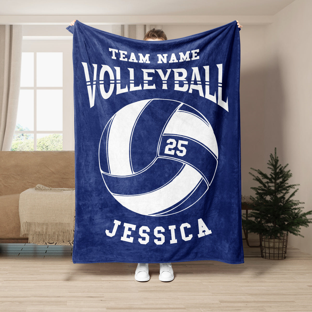 Navy volleyball throw blanket displayed in a living room with bold white ball artwork