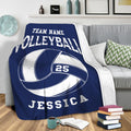 Navy volleyball blanket draped over a sofa with bold sports artwork for lounge decor
