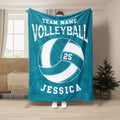 Teal volleyball blanket displayed in a living room with bold white volleyball artwork