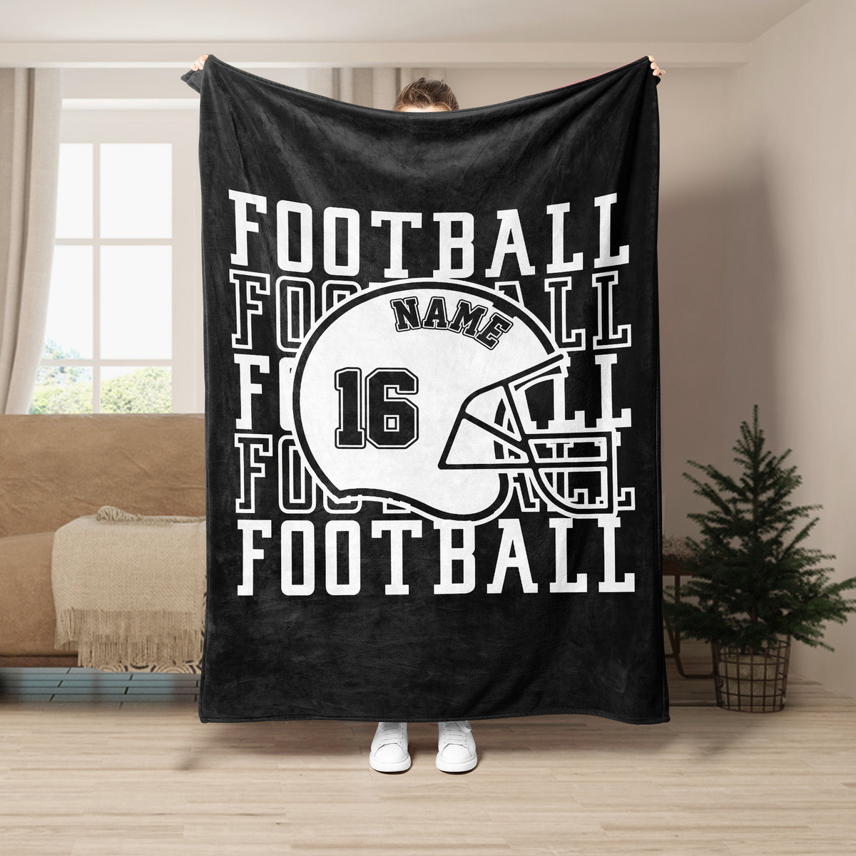 Black football blanket with white helmet artwork and strong athletic lettering