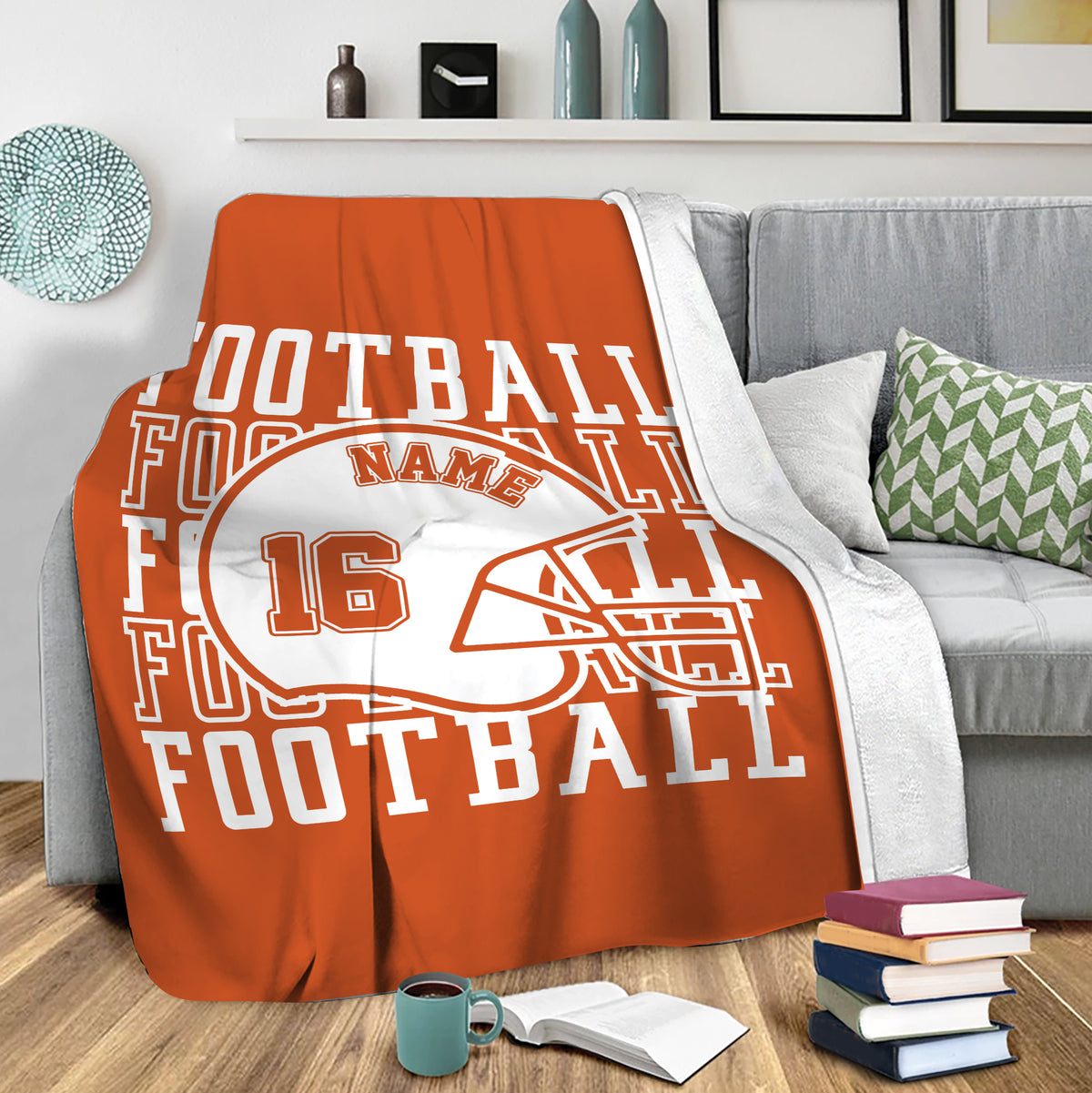 Orange football throw blanket draped over a gray sofa in a cozy living room