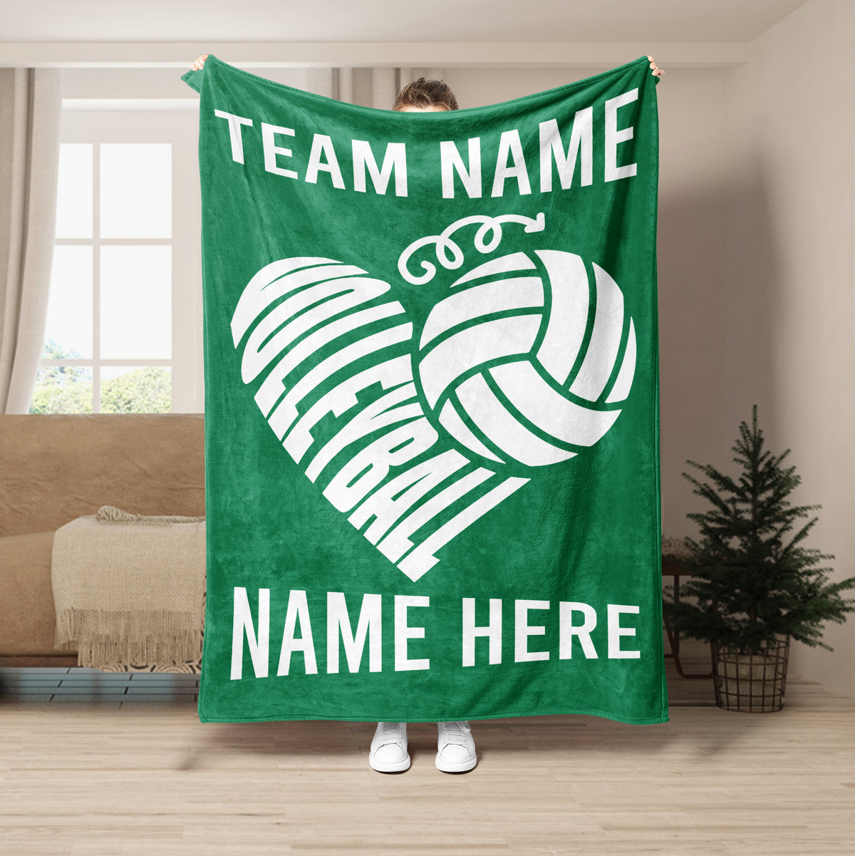 Green volleyball blanket shown in a room setting with white heart-shaped volleyball artwork