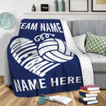 Navy volleyball throw blanket draped over a sofa with bold white volleyball artwork