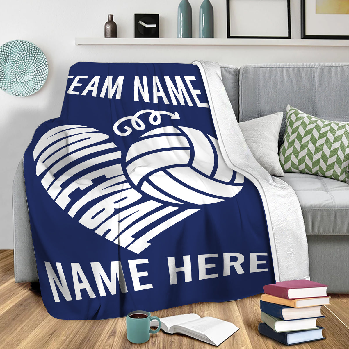 Navy volleyball throw blanket draped over a sofa with bold white volleyball artwork