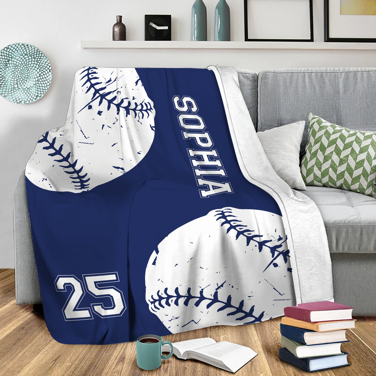 Navy softball throw blanket draped over a gray sofa in a cozy living room