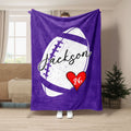 Purple football throw blanket featuring graphic football artwork and a red heart accent