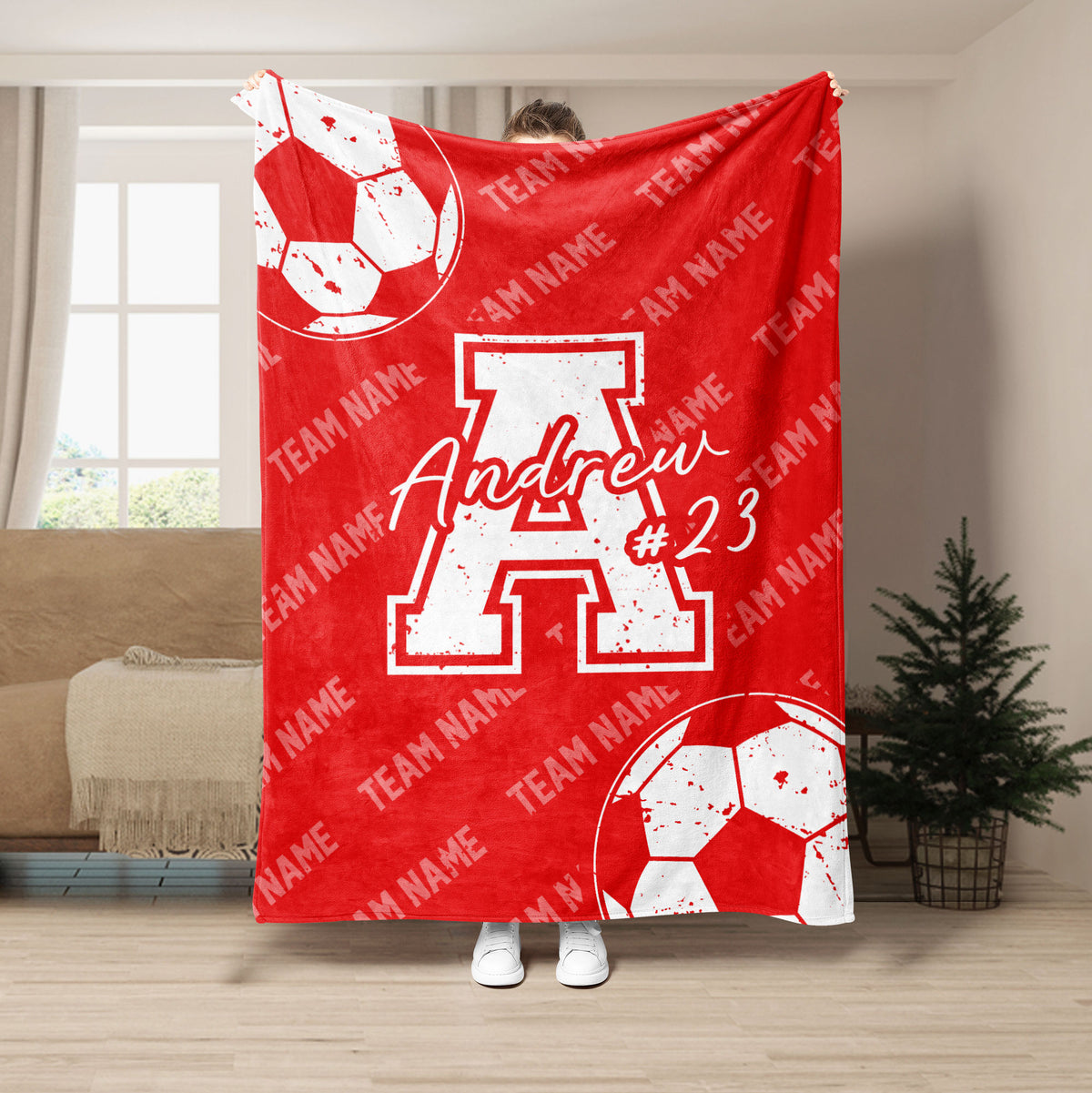 Red soccer blanket with white soccer balls and bold contrasting sports artwork for team-inspired decor