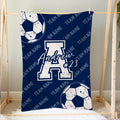 Blue soccer blanket displayed on a bedroom frame with large soccer balls and athletic team graphics
