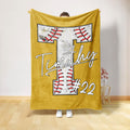Gold baseball throw blanket featuring a large stitched baseball design and bold sports artwork