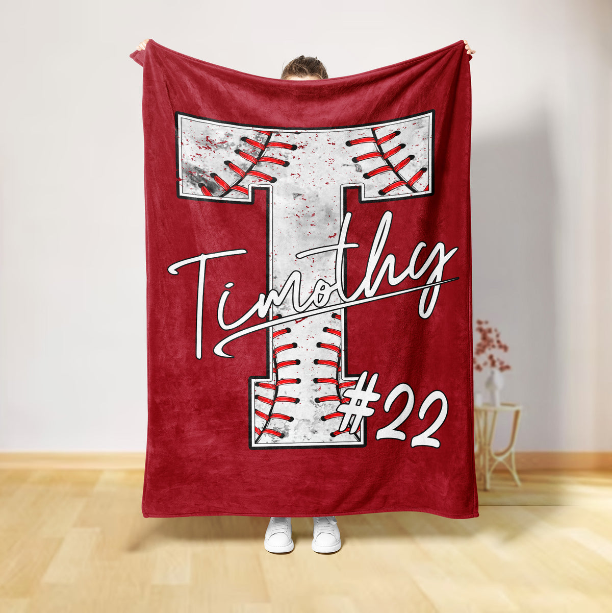 Red baseball throw blanket with oversized stitched baseball artwork and strong contrasting details
