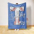 Light blue baseball throw blanket displaying a large stitched baseball design in red, white, and black