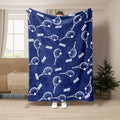Blue tennis blanket featuring repeating white tennis rackets and tennis balls
