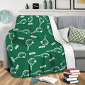 Green tennis blanket draped over a sofa with white racket and ball pattern