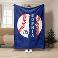 Blue baseball throw blanket shown in a living room with large white ball and red stitching artwork